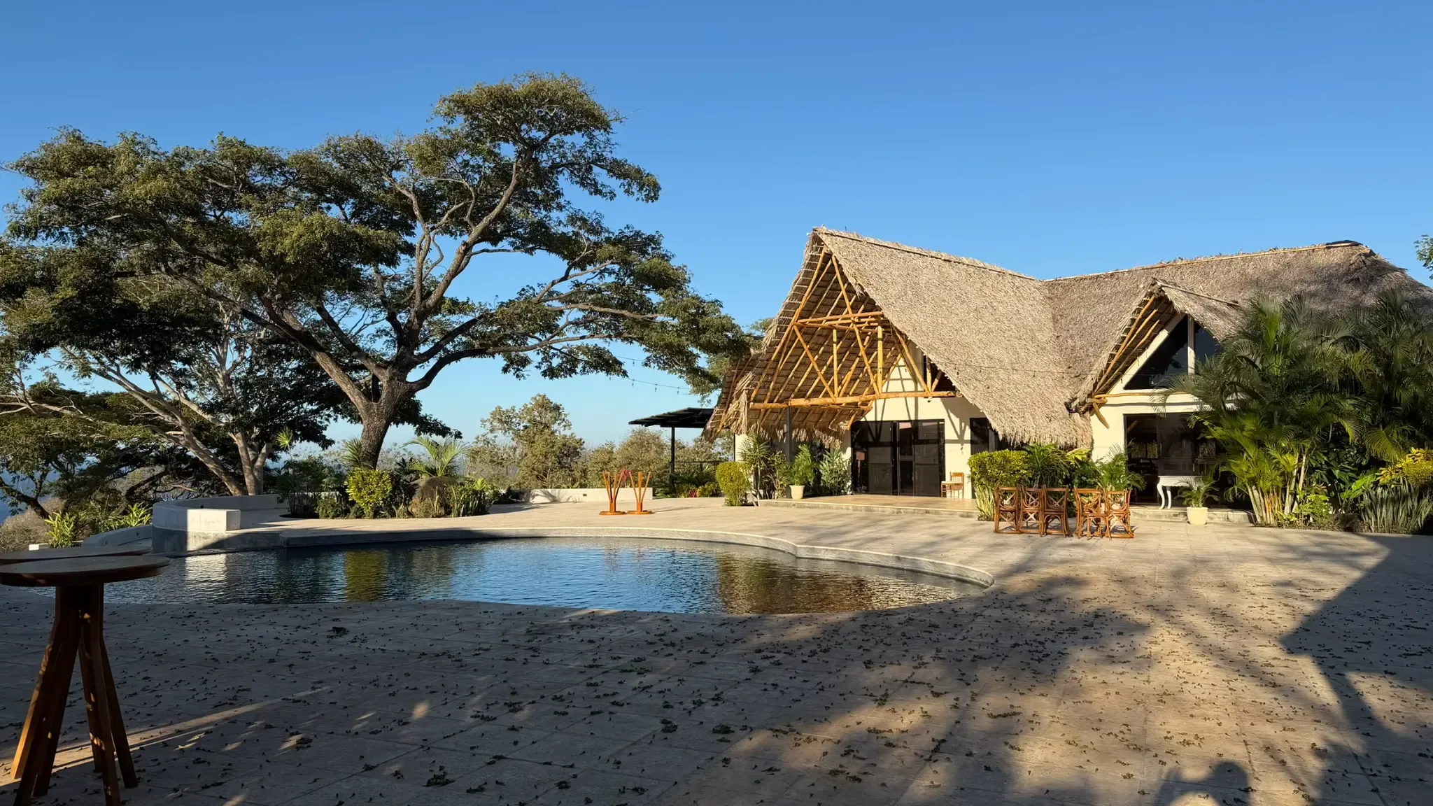 The main pool area with the beautiful thatched-roof restaurant pavilion