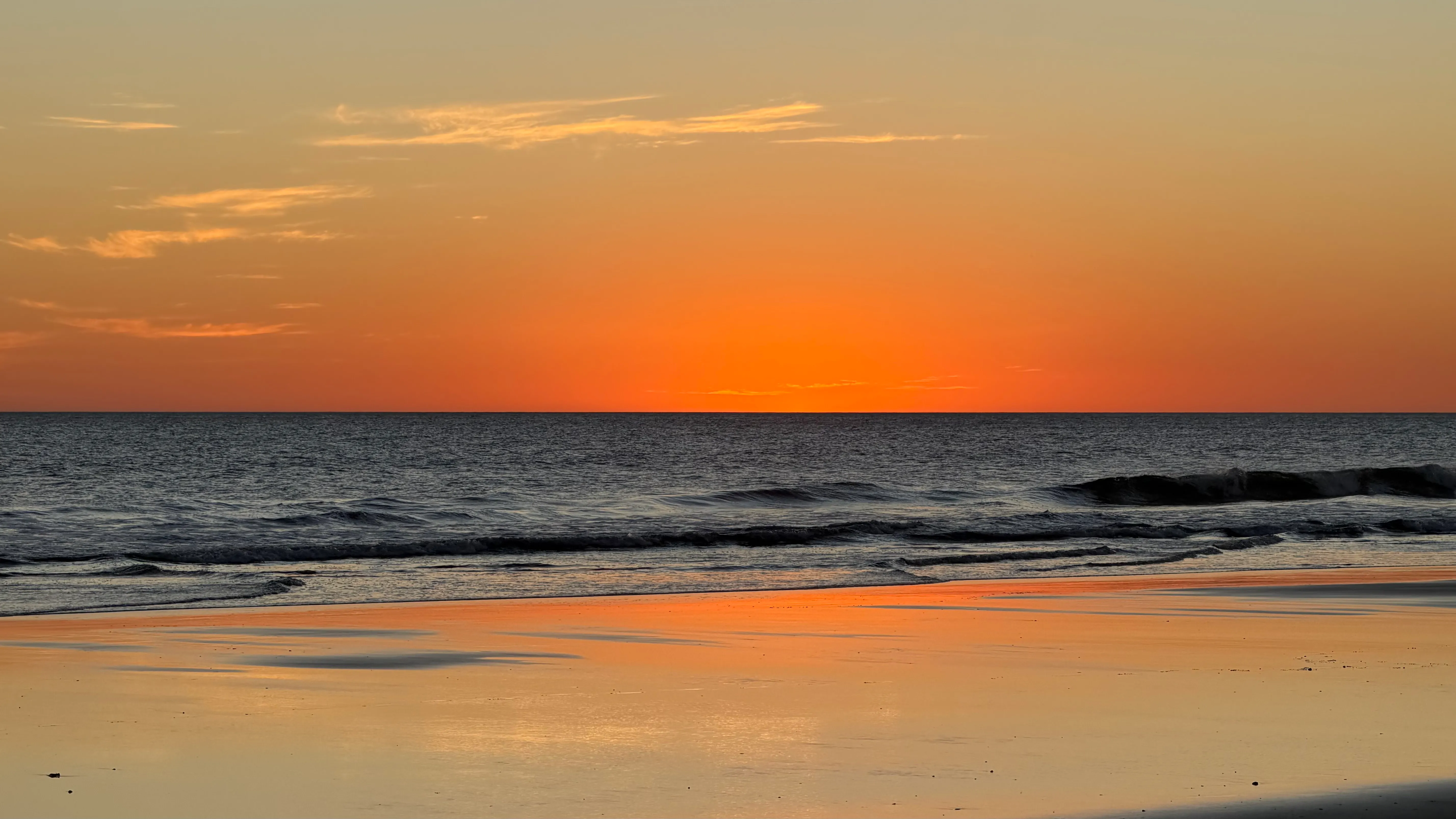 Stunning orange sunset over the Pacific Ocean in Tupilapa, Nicaragua