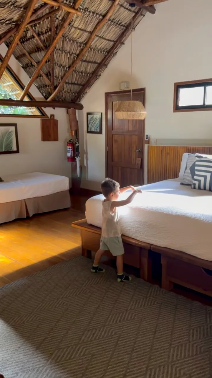 Inside our villa, with its beautiful Parota wood furniture, hardwood floors, and traditional thatched roof